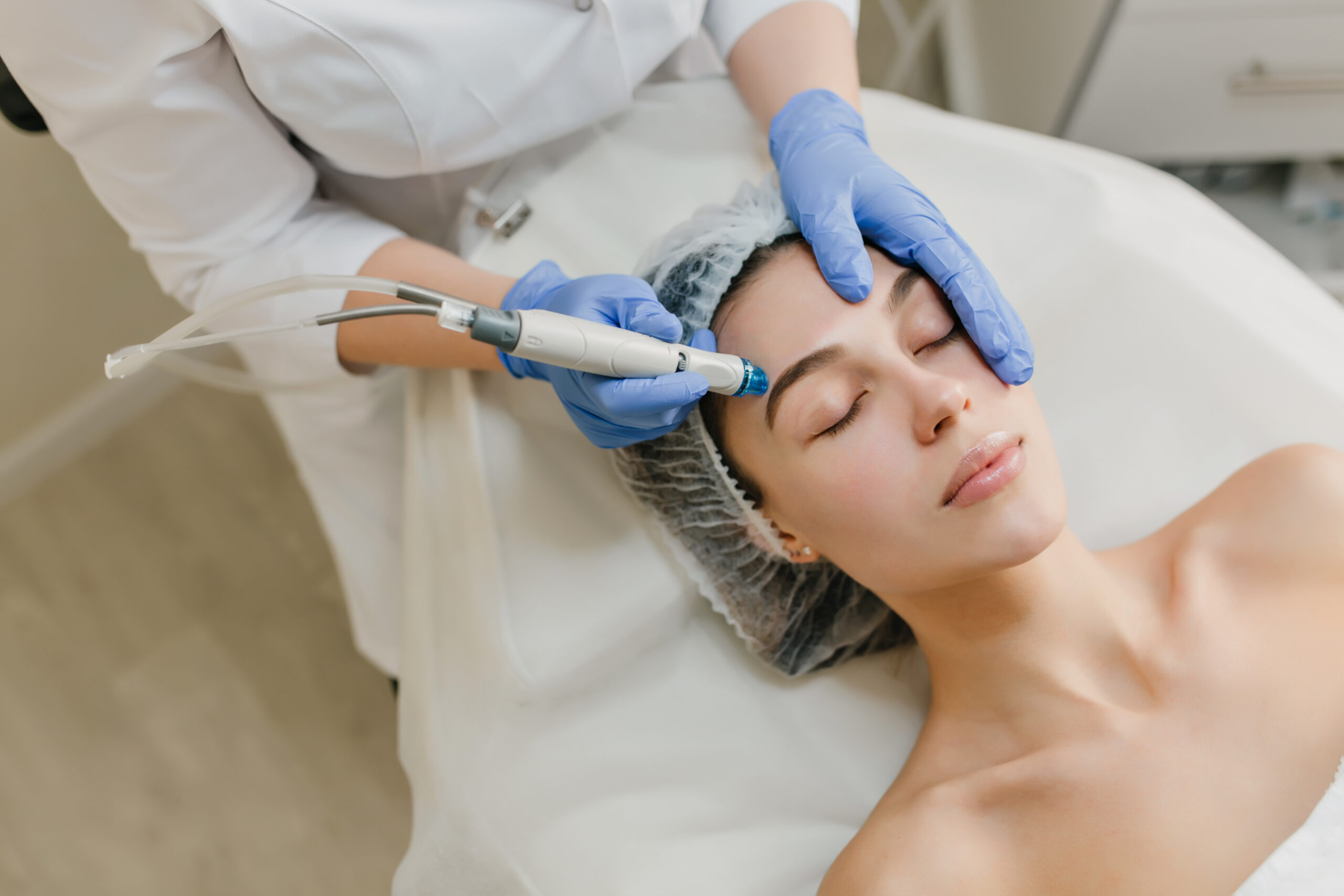 view from rejuvenation beautiful woman enjoying cosmetology procedures beauty salon dermatology hands blue glows healthcare therapy botox scaled.jpg